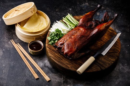 Peking duck is a famous Chinese dish known for its crispy skin and tender meat. Roast a whole duck until the skin turns golden and crispy